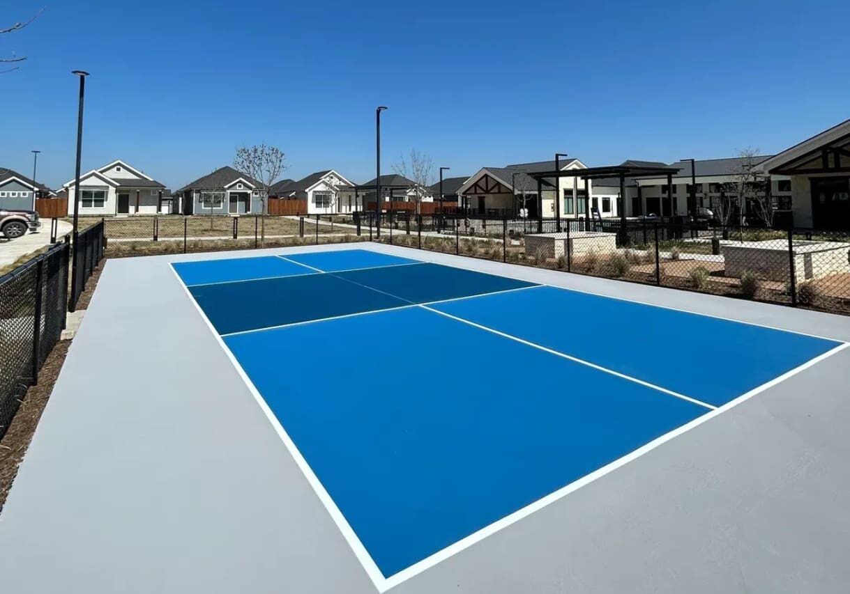 A tennis court with two blue and one black.